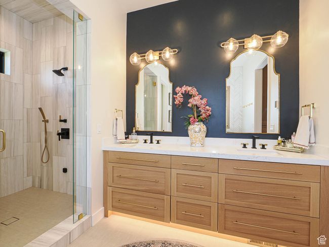 Bathroom featuring a stall shower and double vanity | Image 53
