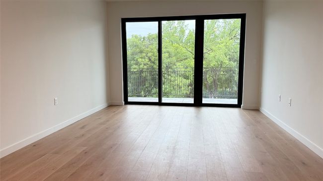 Empty room featuring light wood finished floors and baseboards | Image 4