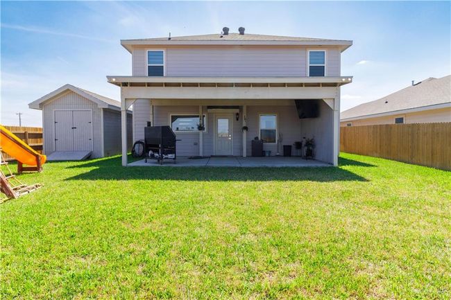 Rear view of house with a patio, a shed, an outdoor structure, and a fenced backyard | Image 18