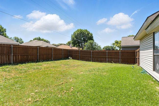 View of fenced backyard | Image 22