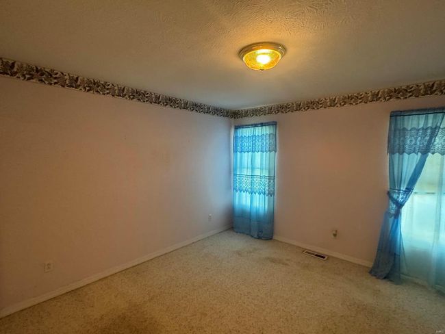 Unfurnished room featuring a textured ceiling and carpet flooring | Image 13