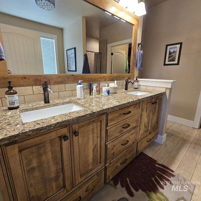Bathroom with double vanity and baseboards | Image 18