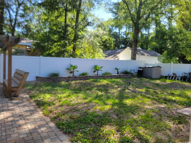 View of fenced backyard | Image 13