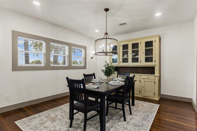 Dining space featuring baseboards, a chandelier, dark wood-style floors, and recessed lighting | Image 13