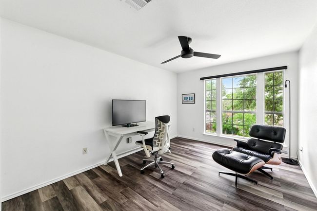 Bedroom with baseboards, dark wood finished floors, and ceiling fan | Image 29