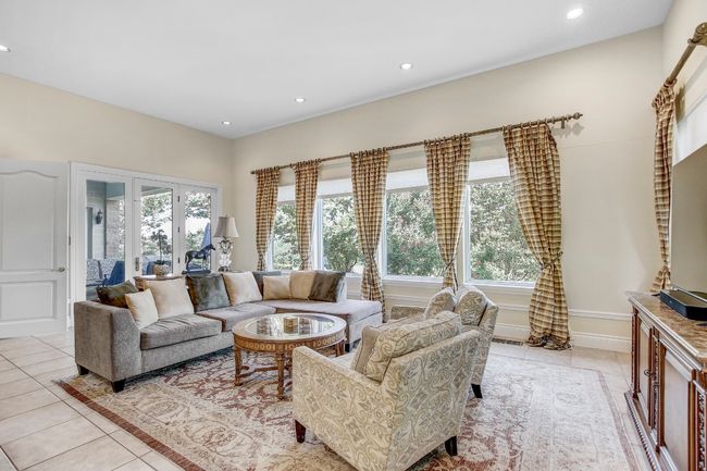 Living area featuring light tile patterned floors, healthy amount of natural light, and recessed lighting | Image 17