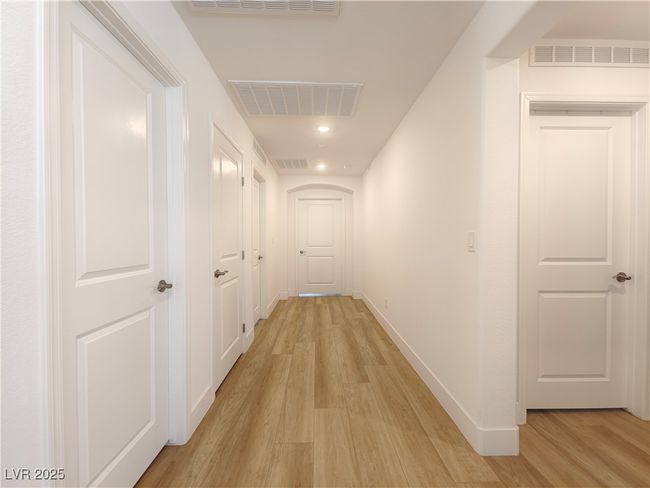 Hallway featuring visible vents, baseboards, and light wood-type flooring | Image 25