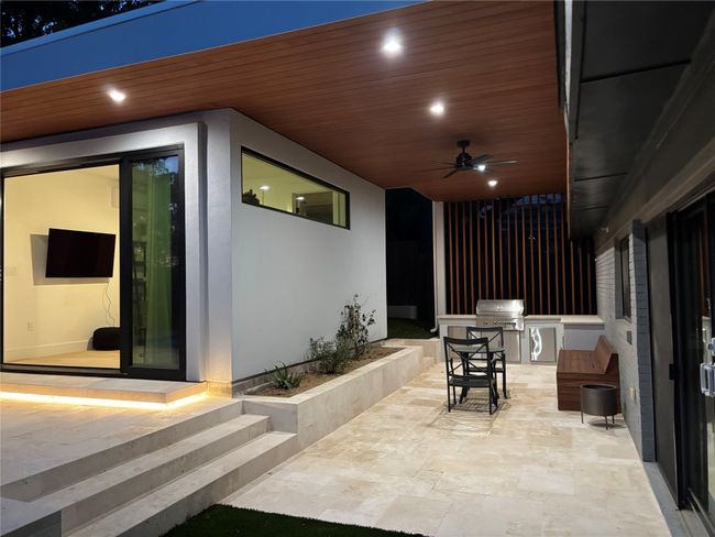 View of patio featuring grilling area and a ceiling fan | Image 40
