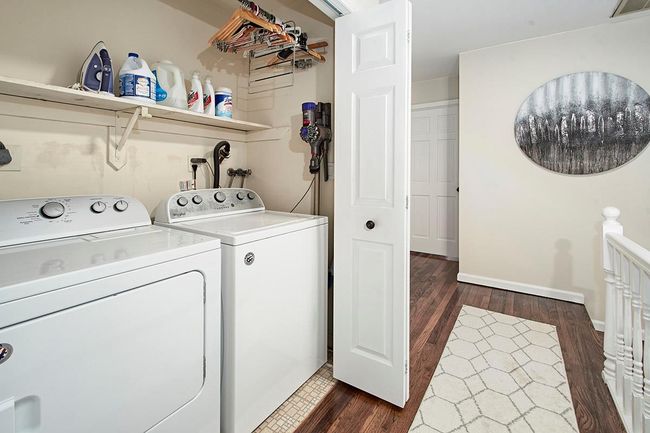 Laundry area featuring washer and dryer, visible vents, dark wood-style floors, and laundry area | Image 17
