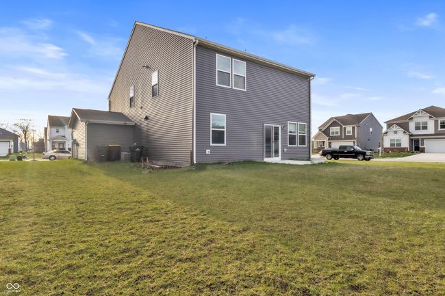 rear view of property with a residential view and a lawn | Image 35
