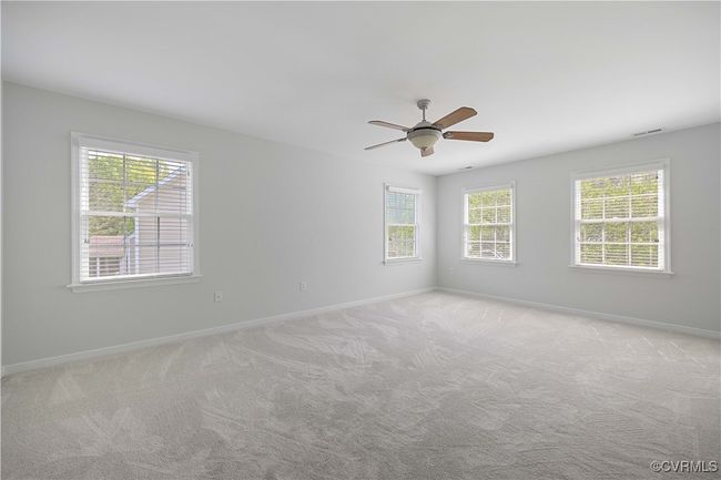 Primary bedroom with ceiling fan, double closets, primary bathroom | Image 35