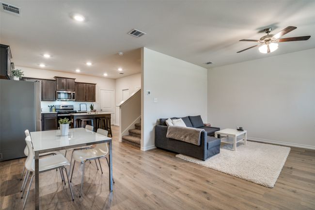Dining area with stairs, ceiling fan, wood finished floors, and recessed lighting | Image 4