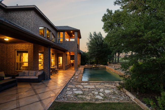 Outdoor pool featuring outdoor lounge area, a patio area, and an in-ground hot tub | Image 35
