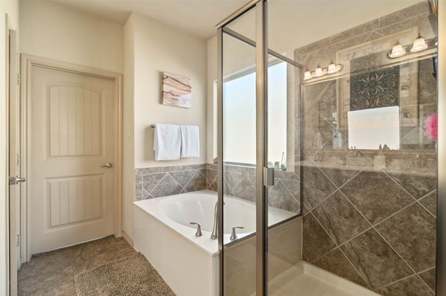 Bathroom with a stall shower and a bath | Image 11