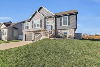 View of front of property with a garage and a front lawn | Image 2