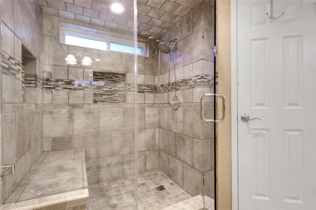 Updated primary shower with dual soap boxes and large bench | Image 24