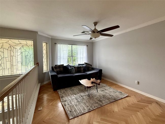 Living room featuring crown molding, a ceiling fan, baseboards, and visible vents | Image 31
