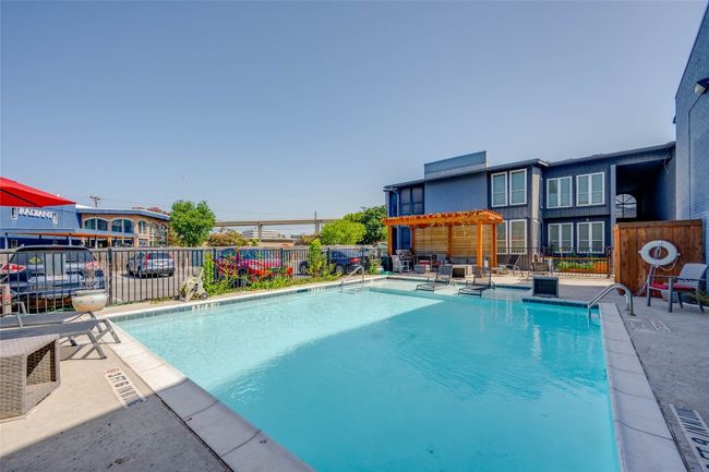 Community pool featuring a fenced backyard, a patio area, and a pergola | Image 24