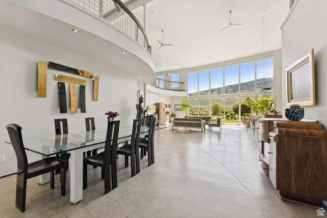 Dining area with a high ceiling, finished concrete floors, and a mountain view | Image 7