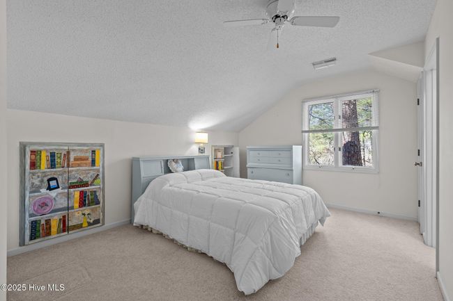 Bedroom 2- additional shelf storage behind the "books" on both side of the bed | Image 22