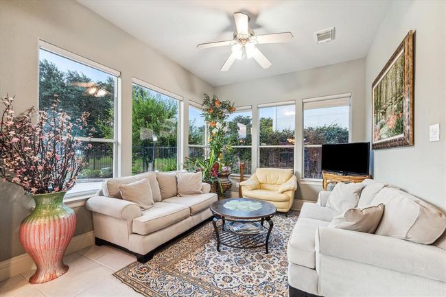 Sunroom offers tons of natural light. Take a look at the next picture to see how you can transform this into a 2nd bedroom downstairs. Home security system is linked to the TV here and STAYS. | Image 13