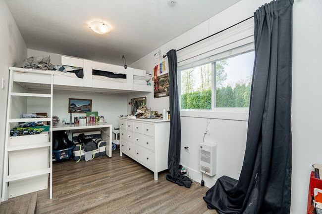 Bedroom featuring wood finished floors and heating unit | Image 19