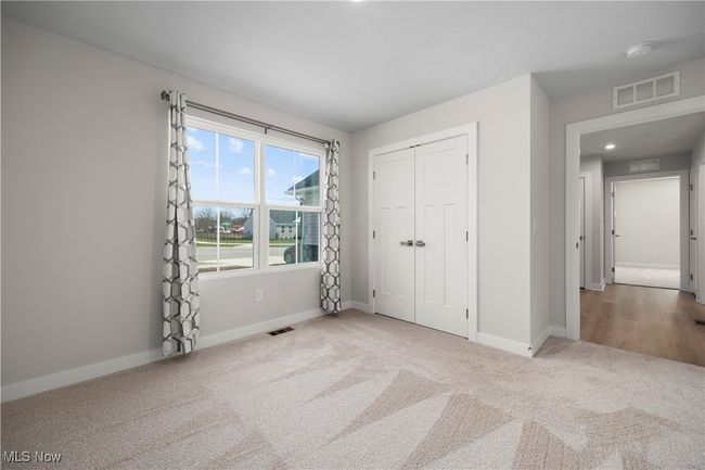 Unfurnished bedroom featuring visible vents, baseboards, a closet, and carpet | Image 7