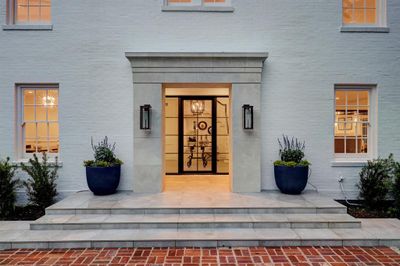 Gorgeous entry with a custom steel framed door welcomes guest into the home. | Image 3