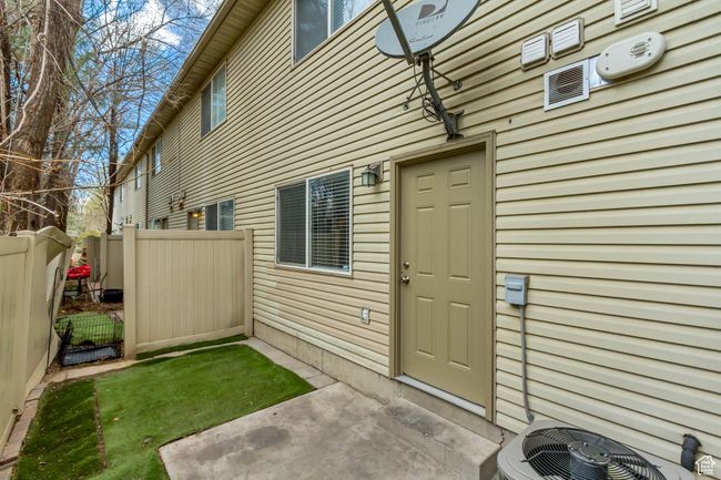 View of exterior entry with central AC unit and fence | Image 16