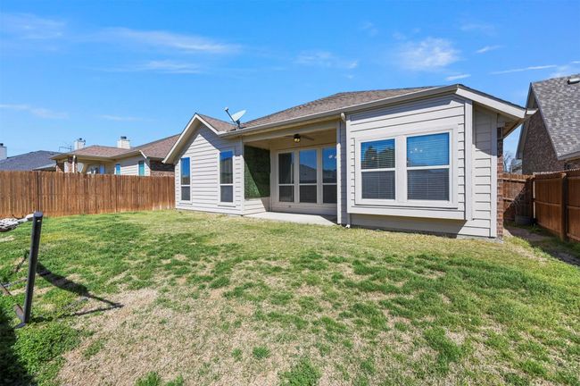 Rear view of house featuring a patio, a lawn, a fenced backyard, and a ceiling fan | Image 38