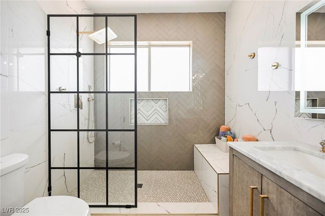 Bathroom with a shower stall, vanity, tile walls, and​​‌​​​​‌​​‌‌​‌‌​​​‌‌​​‌‌​‌​​​​​‌ toilet | Image 46