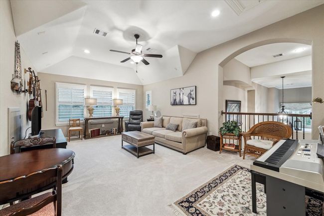 Gameroom, secondary den with open space to the front of the home. Architectural ceiling and plantation shutters are also present here. | Image 23