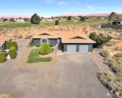 Aerial front view of home with Mature cherry, Apricot trees and landscaping. | Image 1