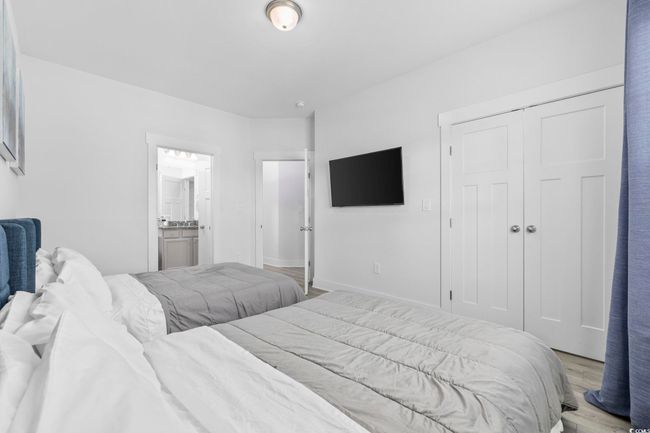 Bedroom featuring light wood-type flooring, a closet, baseboards, and ensuite bathroom | Image 21