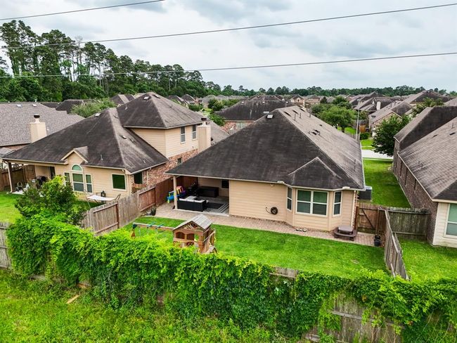 This aerial view just above fence height showcases the generous backyard space and the peaceful privacy of no rear neighbors—your own serene outdoor retreat right at home. | Image 37