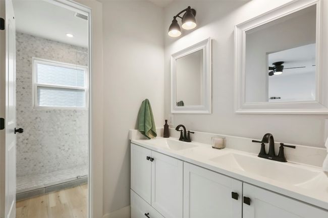 Dual vanties separate shower from walk-in closet | Image 10