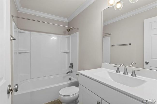 Full bath featuring ornamental molding, vanity, toilet, and shower / tub combination | Image 22