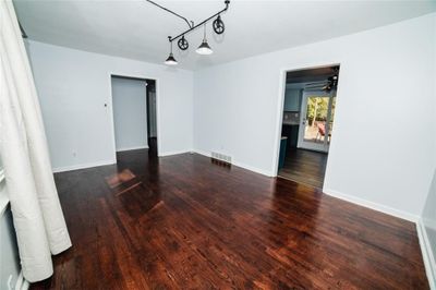 Empty room with dark hardwood / wood-style floors and ceiling fan | Image 3