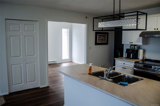 Living room with a baseboard radiator, a tiled fireplace, and baseboards | Image 20