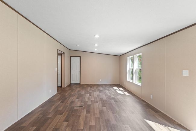 Spare room with wood finished floors, crown molding, and recessed lighting | Image 17