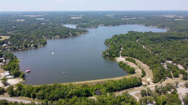 Bird's eye view of a heavily wooded area and a nearby Callender Lake | Image 38