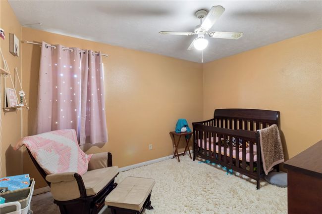 Bedroom with ceiling fan and carpet flooring | Image 21