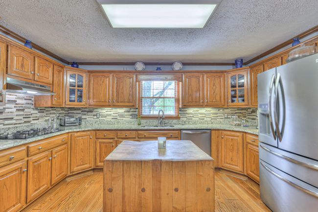 stainless appliances remain- portable butcher block island does not remain | Image 53
