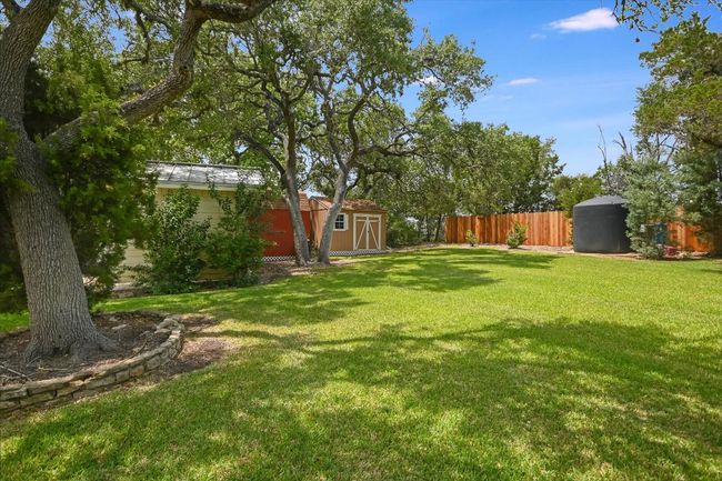 Large storage tank for water & recently installed 8 ft privacy fencing at just the back of the lot. | Image 29