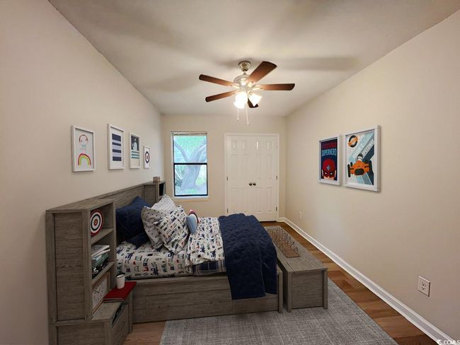 Bedroom featuring baseboards, a ceiling fan, and wood finished floors | Image 24