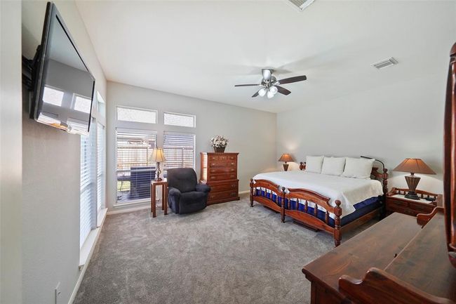 The Primary suite is tucked away for privacy. Nice newer carpet, lots of windows to keep things light and bright. | Image 16