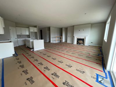 3244 Jandura Ave NE- Dining room view to the kitchen & great room featuring a fireplace with mantle surround and stone accents. Kitchen countertops and decorative stair railing will be installed soon. | Image 2