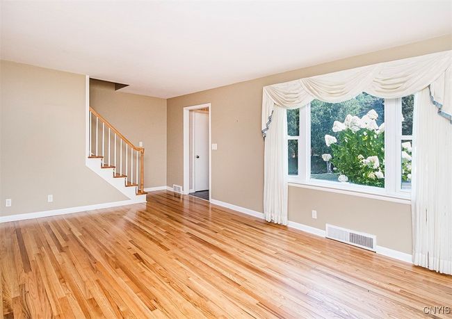 Enter the front door into the formal living room. Natural light spills in through the picture window and look at those newly refinished floors... | Image 4