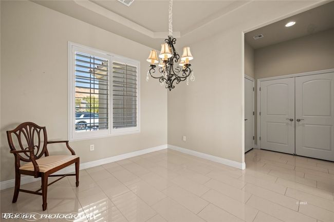 Unfurnished room with a chandelier, visible vents, and baseboards | Image 11