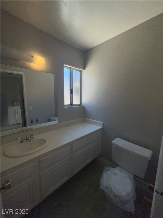 Bathroom featuring toilet and vanity | Image 9